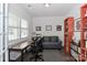 Office space with natural light, grey sofa, dark wood floors, and built in bookcase at 141 Slip Shot Ln, Troutman, NC 28166