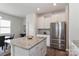 Kitchen island with granite countertop, stainless steel refrigerator, and ample storage space at 141 Slip Shot Ln, Troutman, NC 28166