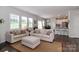 Bright open-concept living room featuring an adjacent kitchen, with hardwood floors and ample natural light at 141 Slip Shot Ln, Troutman, NC 28166