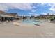 Community pool featuring a splash fountain, surrounded by lounge chairs for relaxing at 141 Slip Shot Ln, Troutman, NC 28166