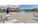 Community pool featuring a splash fountain, surrounded by lounge chairs and tables at 141 Slip Shot Ln, Troutman, NC 28166
