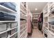 Spacious walk-in closet featuring custom shelving, drawers, and ample storage space for clothes and accessories at 141 Slip Shot Ln, Troutman, NC 28166