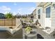 Cozy back porch featuring comfortable wicker chairs, a view of the yard, and potted plants at 14235 Canemeadow Dr # 102, Charlotte, NC 28278