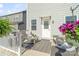 Inviting back porch with wicker furniture, an outdoor rug, and hanging floral arrangements at 14235 Canemeadow Dr # 102, Charlotte, NC 28278