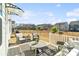 Charming backyard patio setup with stylish outdoor furniture, hanging plants, and a fenced yard at 14235 Canemeadow Dr # 102, Charlotte, NC 28278