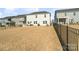 Spacious fenced backyard with a view of the house, patio, and neighboring homes at 14235 Canemeadow Dr # 102, Charlotte, NC 28278
