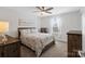Comfortable bedroom with neutral tones, ceiling fan, and natural lighting at 14235 Canemeadow Dr # 102, Charlotte, NC 28278