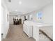 Expansive bonus room with neutral carpet, guitars, and a small dining set at 14235 Canemeadow Dr # 102, Charlotte, NC 28278