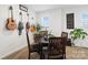 Cozy dining area with round wood table, wall decor, and natural light from the window at 14235 Canemeadow Dr # 102, Charlotte, NC 28278