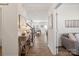 Bright hallway leading to the living room and staircase, featuring hardwood floors and tasteful decor at 14235 Canemeadow Dr # 102, Charlotte, NC 28278