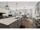 Spacious kitchen overlooking the dining and living areas, featuring gray cabinets and stone countertops at 14235 Canemeadow Dr # 102, Charlotte, NC 28278