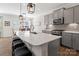 Bright, open kitchen with a large island, stainless steel appliances, and stylish pendant lights at 14235 Canemeadow Dr # 102, Charlotte, NC 28278