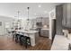 Modern kitchen boasts a center island with seating, stainless steel appliances, and pendant lighting at 14235 Canemeadow Dr # 102, Charlotte, NC 28278
