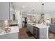 Well-appointed kitchen with stainless steel appliances, a center island, and a view of the adjacent living space at 14235 Canemeadow Dr # 102, Charlotte, NC 28278