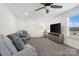 Bright living room with comfortable seating, a ceiling fan, and a view from a window at 14235 Canemeadow Dr # 102, Charlotte, NC 28278