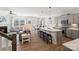 Open-concept living space with a fireplace, kitchen island, and dining area, perfect for entertaining at 14235 Canemeadow Dr # 102, Charlotte, NC 28278