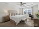 Serene main bedroom with a tray ceiling, carpet flooring, and a dedicated workspace by the window at 14235 Canemeadow Dr # 102, Charlotte, NC 28278