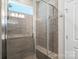 A modern glass shower boasts tiled walls, and built-in bench, plus natural light at 14235 Canemeadow Dr # 102, Charlotte, NC 28278