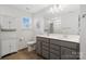 Bathroom with a double vanity, white cabinets, and wood-style flooring at 14235 Canemeadow Dr, Charlotte, NC 28278