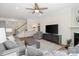 Bright living room with a fireplace, comfortable seating, a staircase, and built-in bookshelves at 14235 Canemeadow Dr, Charlotte, NC 28278