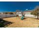 Fenced backyard features a playset, providing a safe and fun outdoor space at 1519 Arcadia Bluff Dr, York, SC 29745