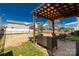 Spacious backyard with a pergola-covered patio, playground, and manicured lawn at 1519 Arcadia Bluff Dr, York, SC 29745