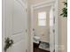 Half bathroom with white fixtures, neutral walls, and wood look flooring at 1519 Arcadia Bluff Dr, York, SC 29745