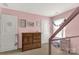 Bright bedroom with pink walls, decorative accents, wood dresser, and a window providing natural light at 1519 Arcadia Bluff Dr, York, SC 29745
