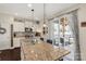 Open kitchen with a large island, granite countertops, stainless steel appliances, and access to the backyard patio at 1519 Arcadia Bluff Dr, York, SC 29745