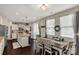 Eat-in kitchen featuring a large dining table, island, stainless appliances, and sliding glass doors to the outdoor patio at 1519 Arcadia Bluff Dr, York, SC 29745