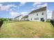 A large grassy backyard with a black fence and a patio that creates a private outdoor space at 16200 Winfield Hall Dr, Charlotte, NC 28273