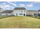 View of the backyard showing a large, well-kept lawn, privacy fence, and a patio perfect for Gathering gatherings at 16200 Winfield Hall Dr, Charlotte, NC 28273