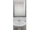 Elegant bathroom features a pedestal sink with decorative mirror and stylish fixtures at 16200 Winfield Hall Dr, Charlotte, NC 28273