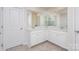 Well-lit bathroom featuring double sinks, vanity with ample storage, and modern finishes at 16200 Winfield Hall Dr, Charlotte, NC 28273