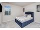 Charming bedroom with a plush blue bed, decorative artwork, and bright window at 16200 Winfield Hall Dr, Charlotte, NC 28273