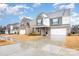 Two-story home showcasing a brick and siding exterior, a two-car garage, and a well-manicured front lawn at 16200 Winfield Hall Dr, Charlotte, NC 28273