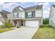 Charming two-story home with a two-car garage, covered porch and nicely landscaped front yard at 16200 Winfield Hall Dr, Charlotte, NC 28273