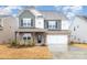 Charming two-story home featuring a mix of stone and siding, complemented by a well-manicured front yard at 16200 Winfield Hall Dr, Charlotte, NC 28273