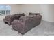 Spacious living room with gray couches and carpeted floors, featuring a bright window at 16200 Winfield Hall Dr, Charlotte, NC 28273