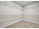 Large walk-in closet is carpeted and outfitted with multiple wire rack shelving units at 2029 Mantle Ridge Dr, Indian Trail, NC 28079