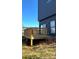 A backyard with a wooden deck and minimal landscaping, beneath a clear blue sky at 211 S Webb St, Gastonia, NC 28052