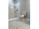 Bathroom featuring a walk-in shower and marble-patterned tile flooring at 211 S Webb St, Gastonia, NC 28052