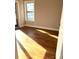 Bright bedroom with wood floors and a window, providing natural light and a view at 211 S Webb St, Gastonia, NC 28052