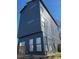 Gray home exterior showcasing multiple windows on each floor, creating bright interiors at 211 S Webb St, Gastonia, NC 28052