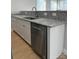 Kitchen featuring granite countertops, white cabinets, a stainless steel dishwasher, and wood-look floors at 211 S Webb St, Gastonia, NC 28052