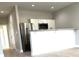 Open kitchen area with stainless steel appliances, a peninsula, and white cabinets at 211 S Webb St, Gastonia, NC 28052