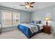 Comfortable bedroom featuring a ceiling fan, natural light from the window, and neutral carpet at 21812 Chapel Way # 20, Cornelius, NC 28031