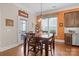 Bright kitchen nook with wood floors, stylish light fixture, and complementary orange accent wall at 21812 Chapel Way # 20, Cornelius, NC 28031