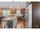 Charming kitchen features a wine rack island, stainless steel appliances, and warm wood cabinets at 21812 Chapel Way # 20, Cornelius, NC 28031
