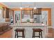 Kitchen island with granite countertops, stylish pendant lighting, and comfortable seating in a modern space at 21812 Chapel Way # 20, Cornelius, NC 28031
